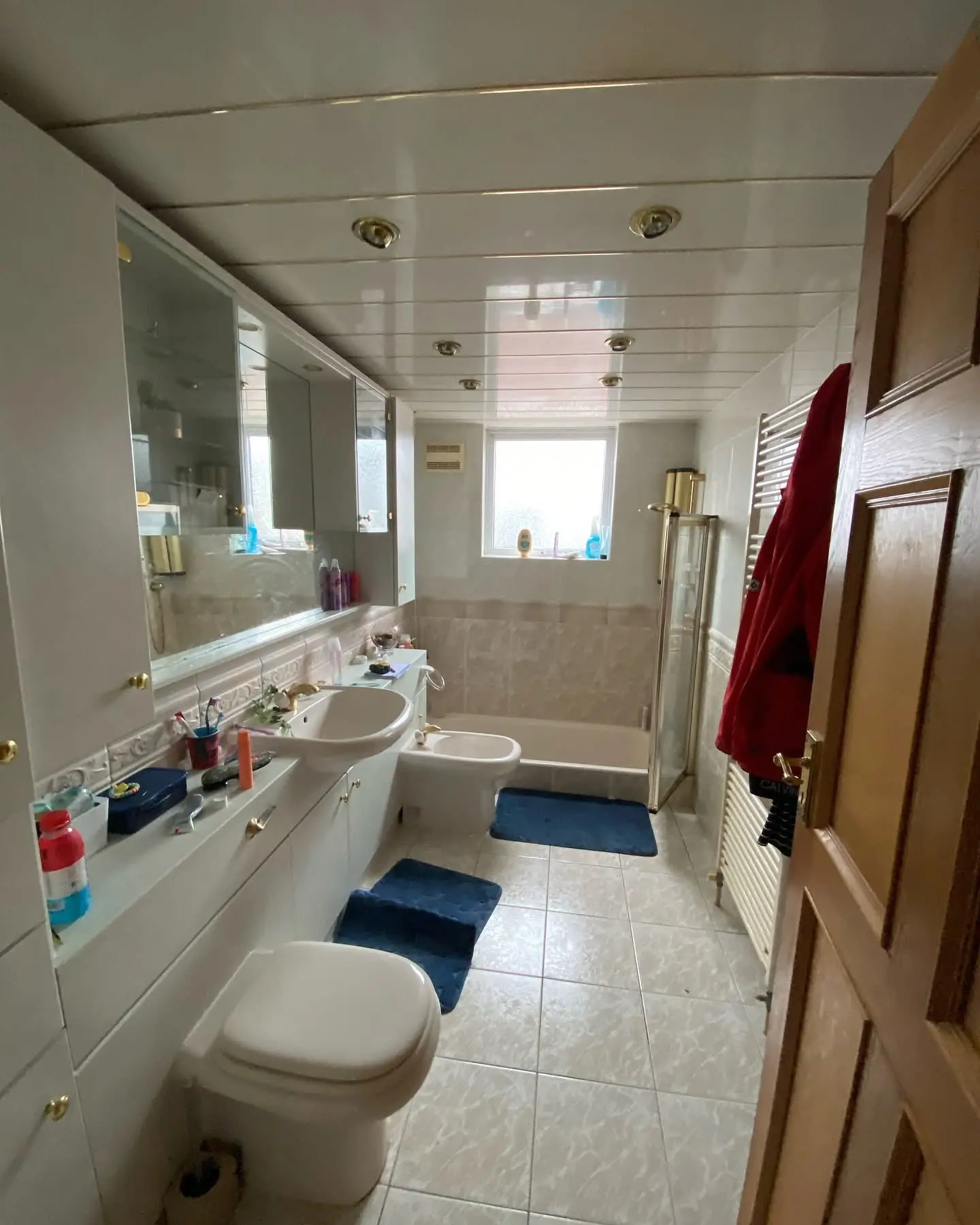 Bathroom before fitting Barnet - dated bathroom with gold fittings and plastic ceiling panels replaced by Resale Refurbs Ltd
