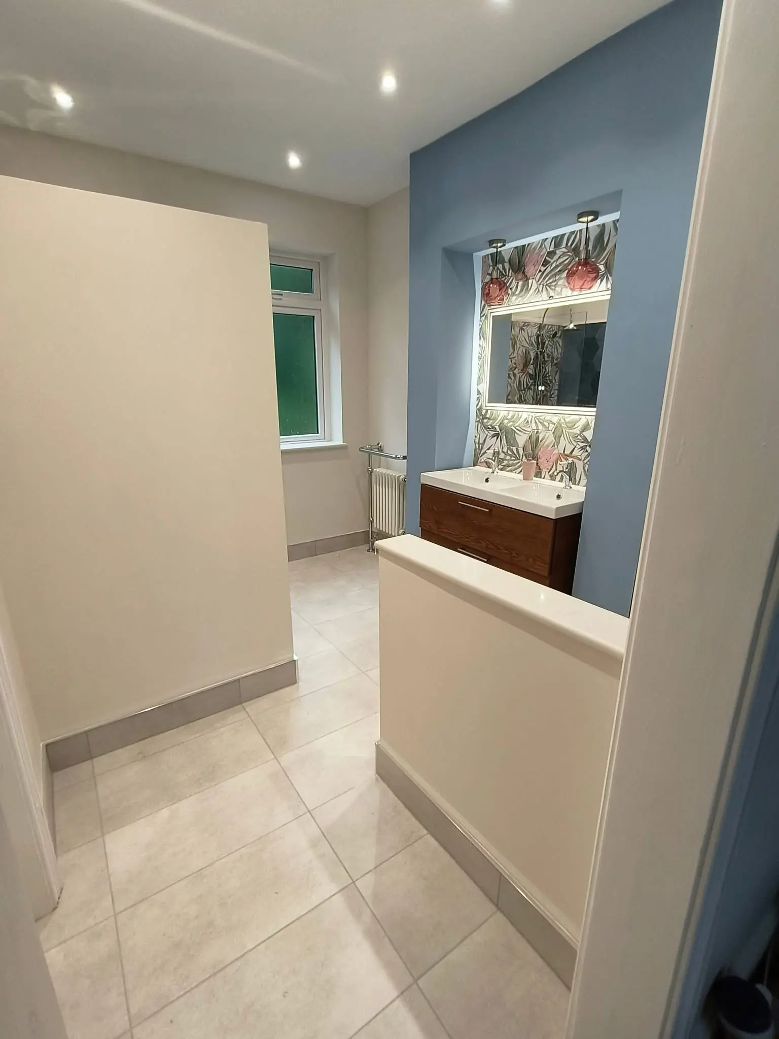 Bathroom fitting Enfield full layout showing double vanity, tiled floor and period towel radiator - Resale Refurbs Ltd