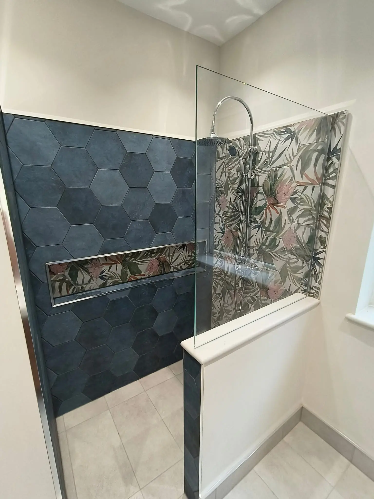Bathroom fitting Enfield walk-in shower with dark hexagonal tiles and botanical feature wall - Resale Refurbs Ltd