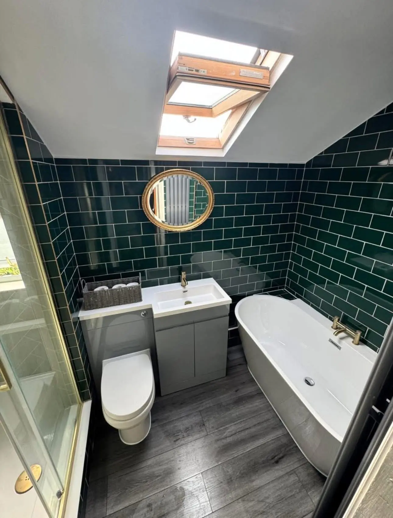 Bathroom fitting London — green metro tiles with freestanding bath and gold fixtures — Resale Refurbs Ltd