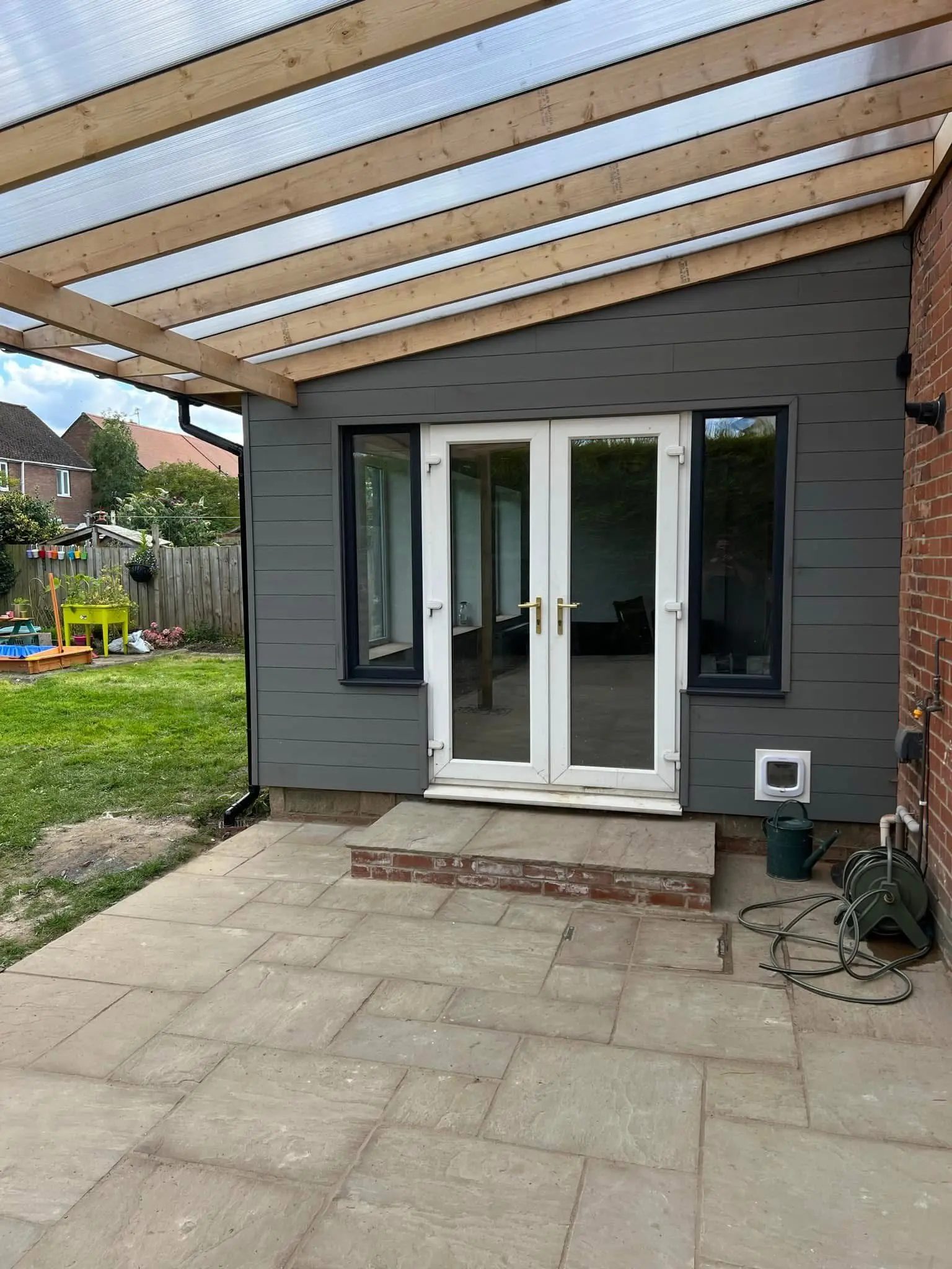 House refurbishment Barnet garden room with pergola, patio and cladding - Resale Refurbs Ltd