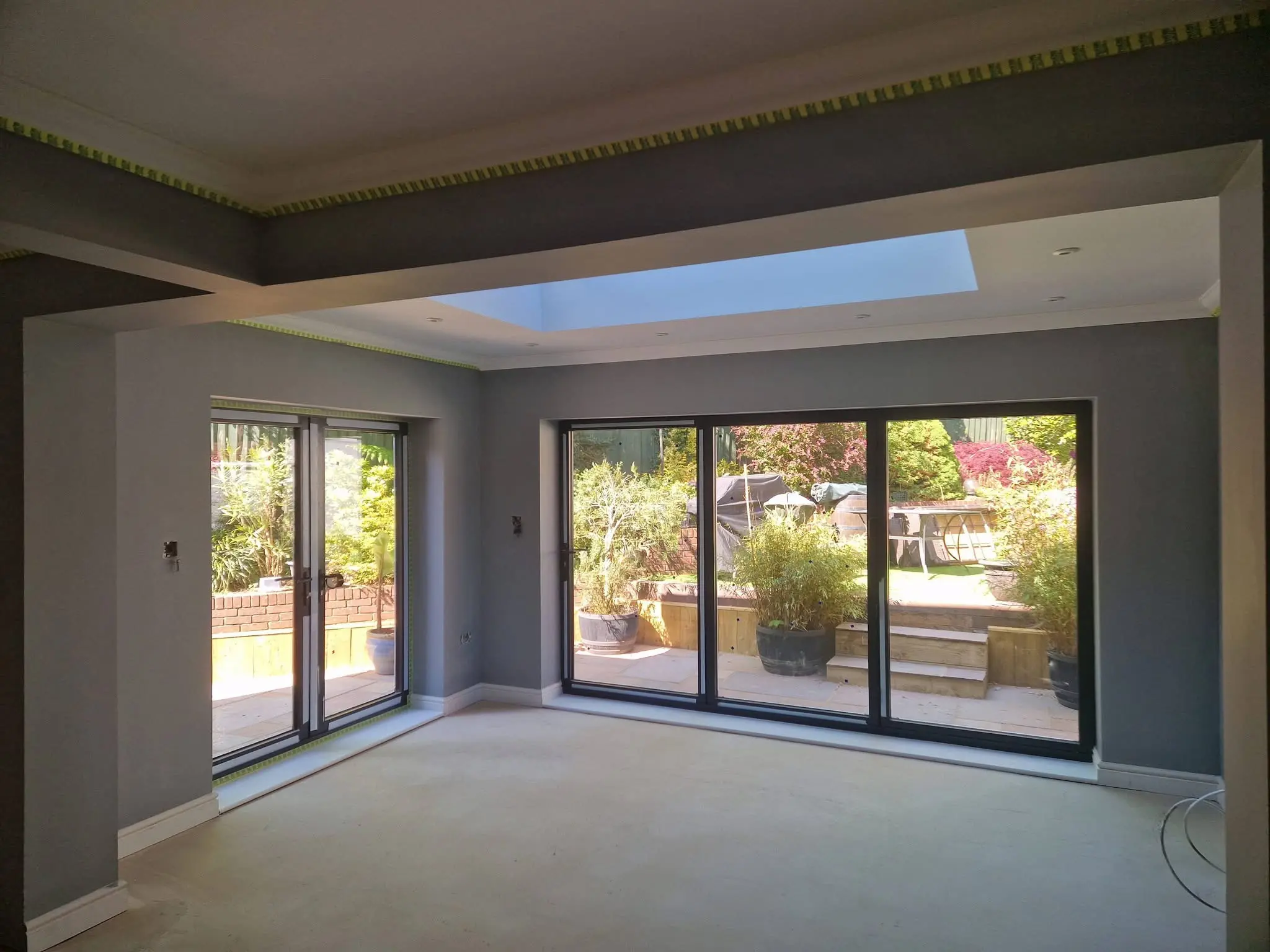 House refurbishment Enfield rear extension complete with full-width bifold doors opening to garden - Resale Refurbs Ltd