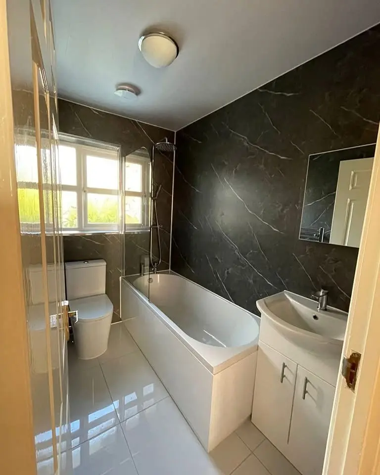 House refurbishment North London bathroom with dark marble finish and bath shower - Resale Refurbs Ltd