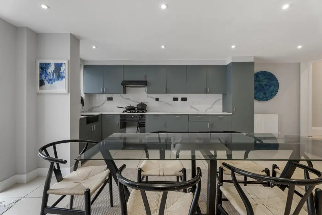 Grey kitchen refurbishment Barnet North London with marble effect worktop and black appliances — Resale Refurbs Ltd