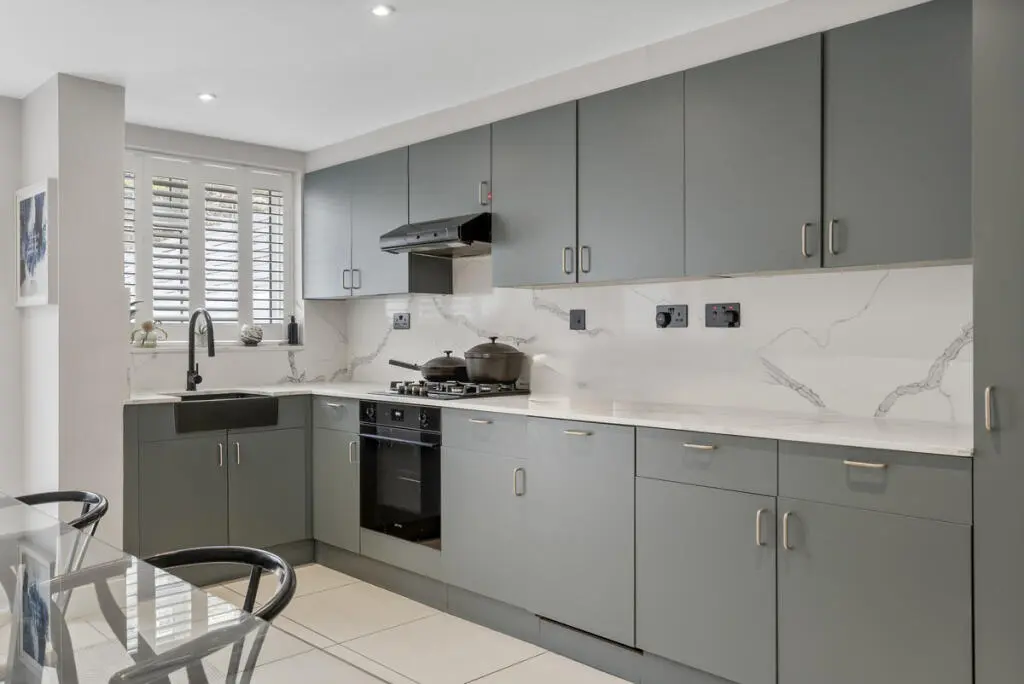 Grey handleless kitchen refurbishment Barnet London with marble splashback and integrated oven — Resale Refurbs Ltd