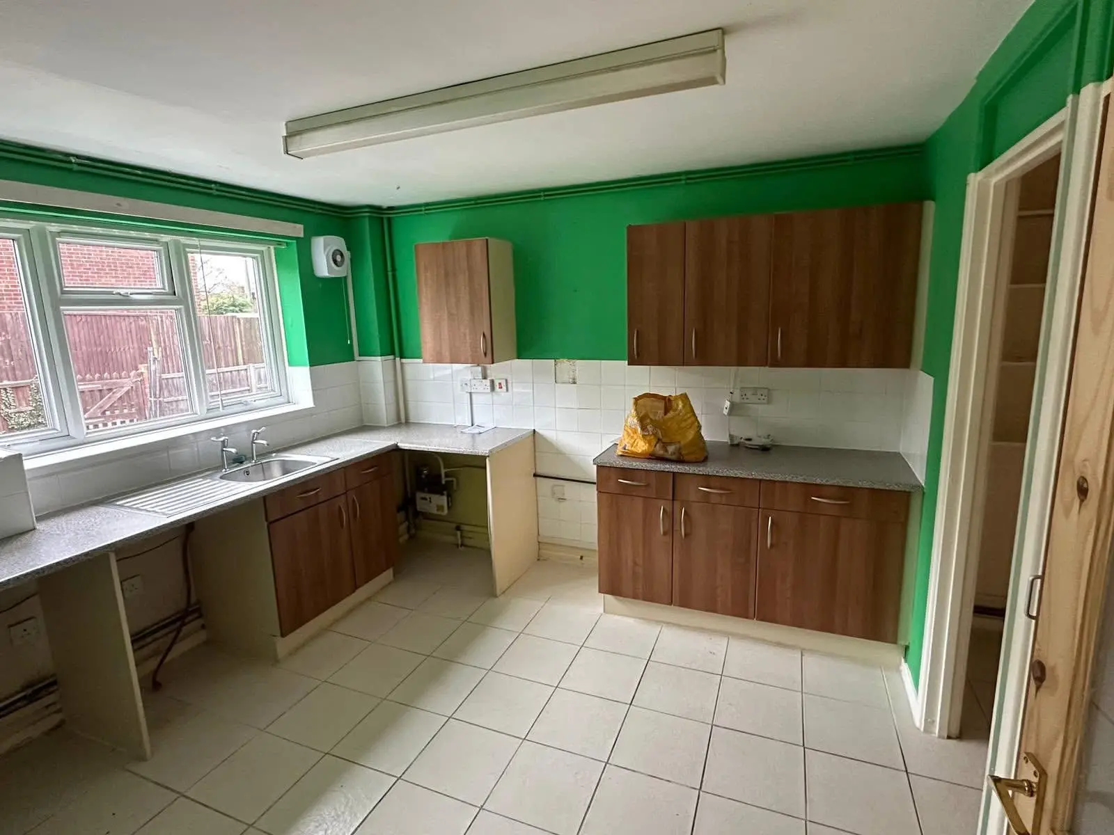 Kitchen before renovation Barnet - dated green and brown kitchen replaced by Resale Refurbs Ltd