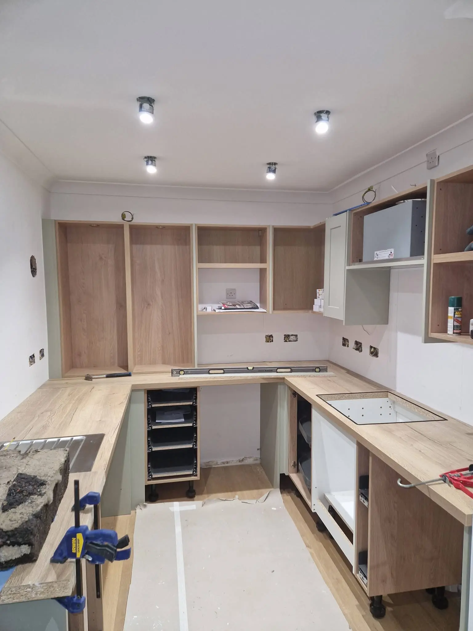 Kitchen renovation Enfield during fit - carcasses installed with electrics being routed - Resale Refurbs Ltd
