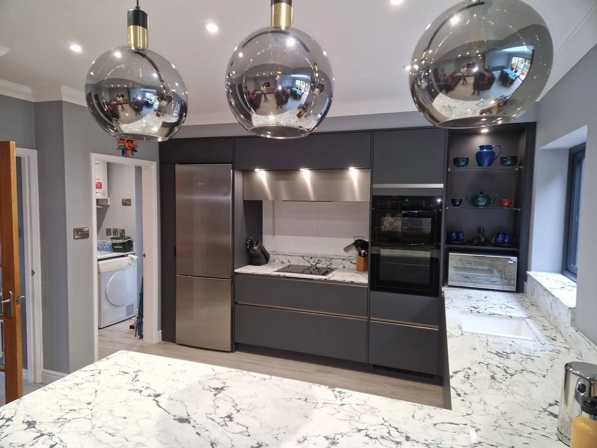 Kitchen renovation Enfield dark handleless units with integrated double oven and open shelving - Resale Refurbs Ltd